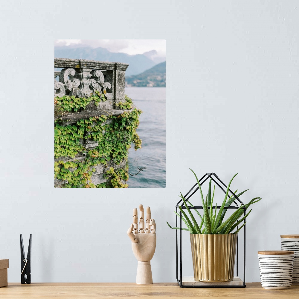 A bohemian room featuring A photograph of an ornate stone balcony covered with ivy on the shore of Lake Como, Italy.