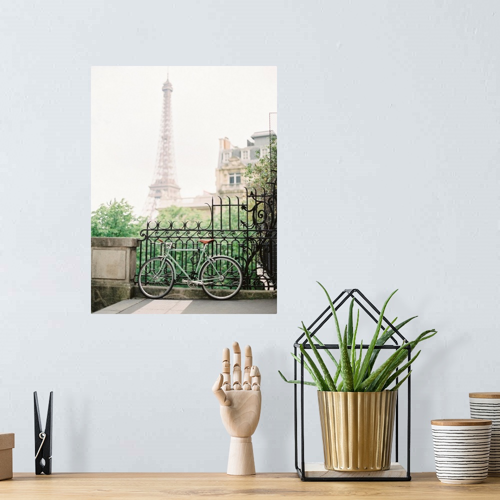 A bohemian room featuring Photograph of a bicycle leaning against an ornate metal railing with the Eiffel tower in the dist...