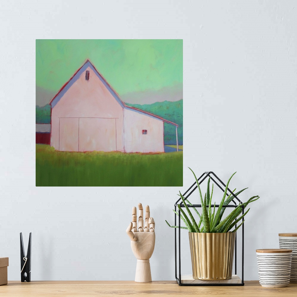 A bohemian room featuring Square artwork of an agricultural building on a green countryside against a bright mint sky.