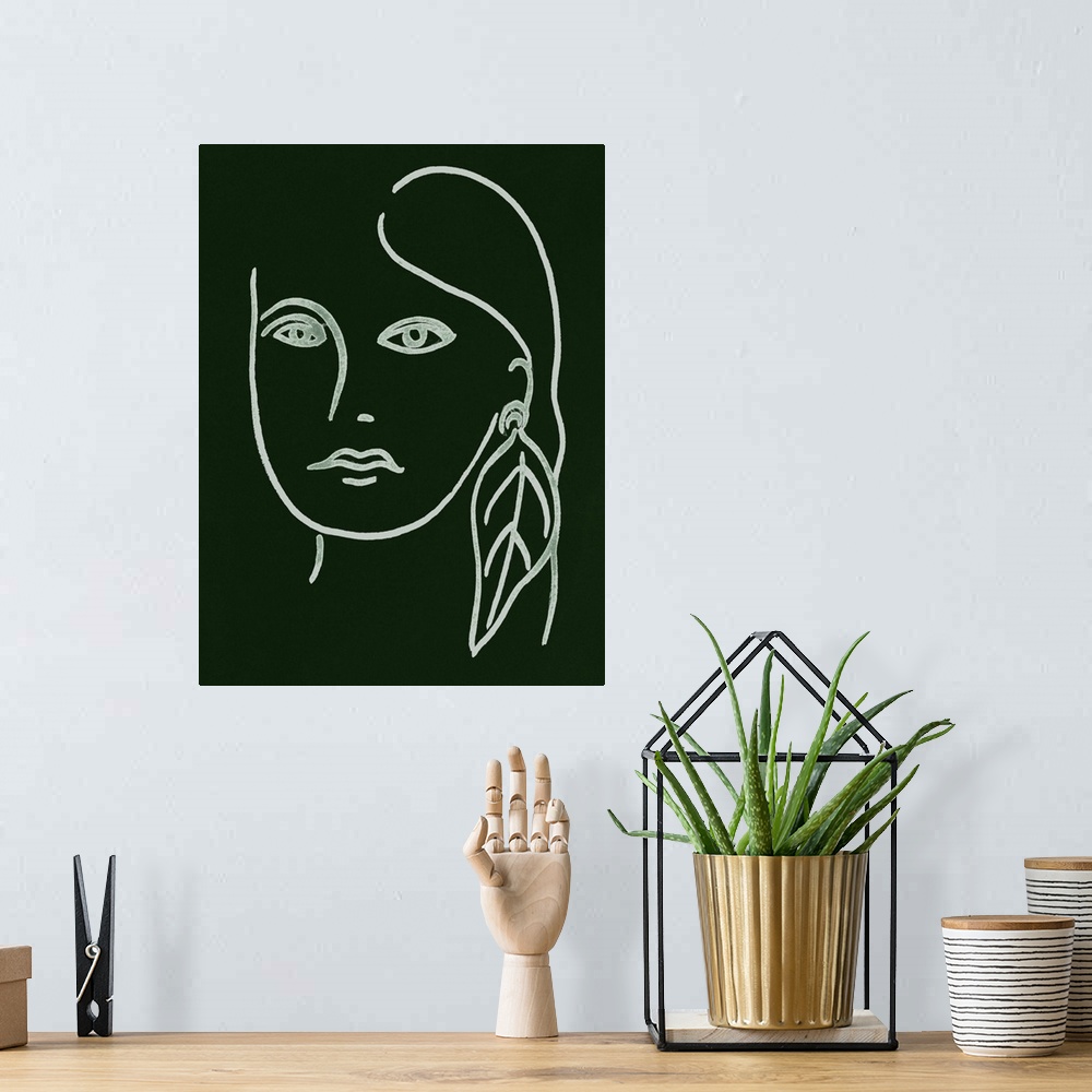A bohemian room featuring Portrait outline of a woman wearing a feather earring on a dark green background.