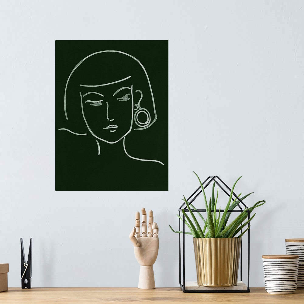 A bohemian room featuring Portrait outline of a woman wearing a fashionable earring on a dark green background.