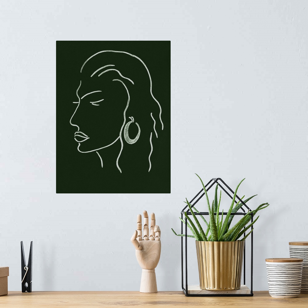 A bohemian room featuring Portrait outline of a woman wearing a fashionable earring on a dark green background.
