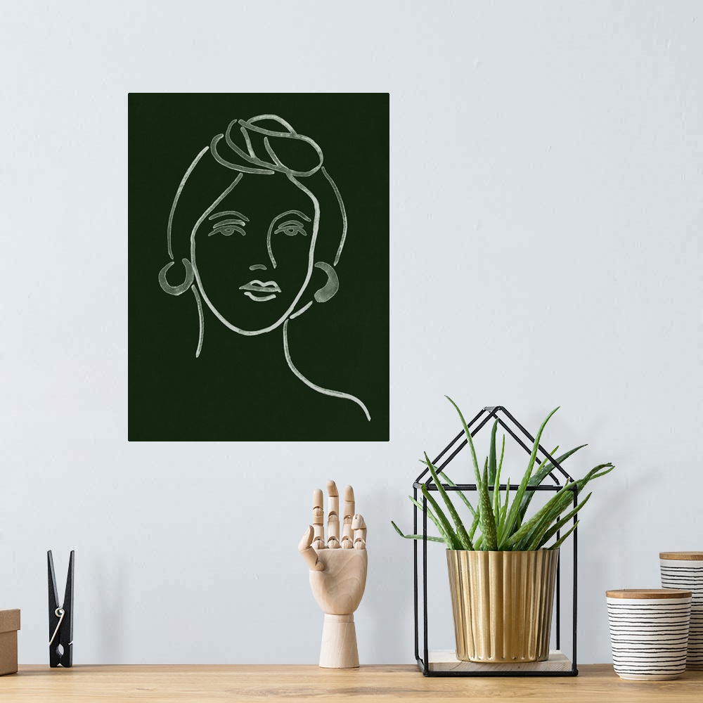 A bohemian room featuring Portrait outline of a woman on a dark green background.