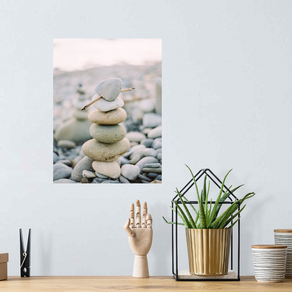 A bohemian room featuring Photograph of stack of small pebbles on the beach, California.