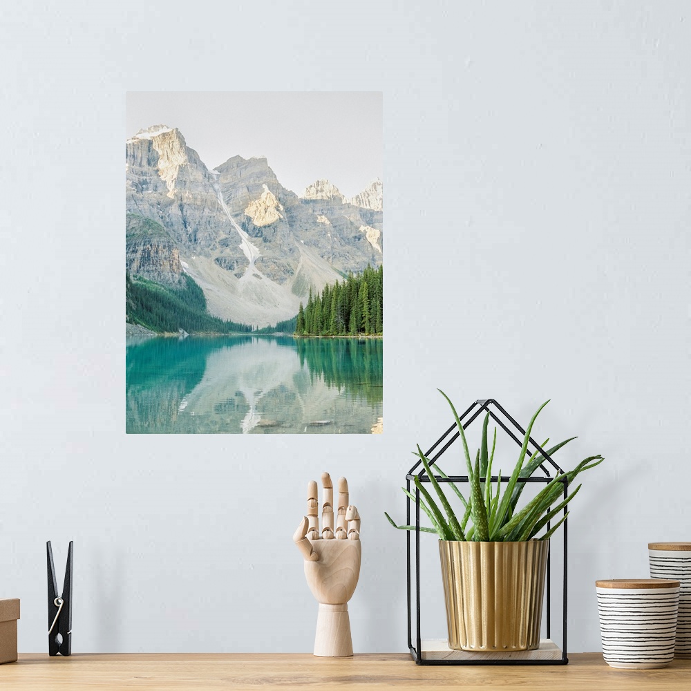 A bohemian room featuring A vertical photograph of the mountains and trees reflected in Moraine Lake, Banff national park, ...