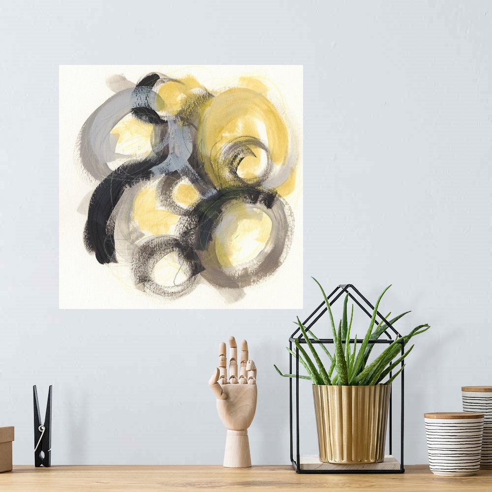 A bohemian room featuring Contemporary abstract painting of circles made from broad strokes with a golden center against a ...