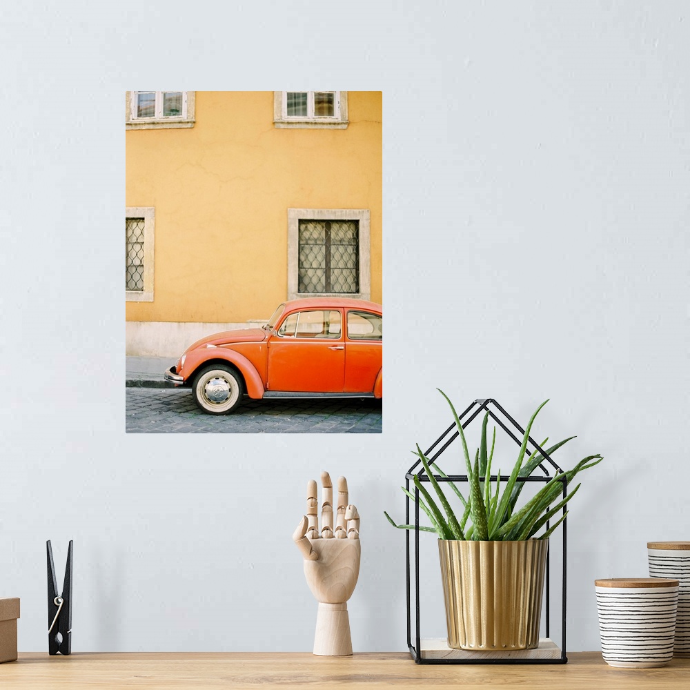 A bohemian room featuring Photograph of an orange Volkswagen Beetle car parked in front of a yellow wall, Budapest, Hungary.