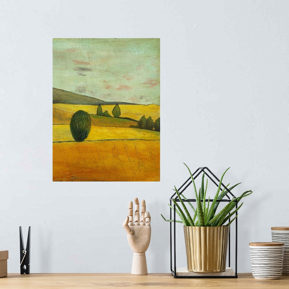 A bohemian room featuring Contemporary painting of a golden landscape of rolling countryside hills.