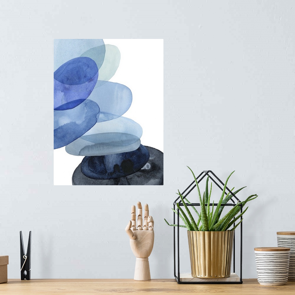 A bohemian room featuring Abstract watercolor painting of oval shapes, representing river stones, stacked on top of each ot...