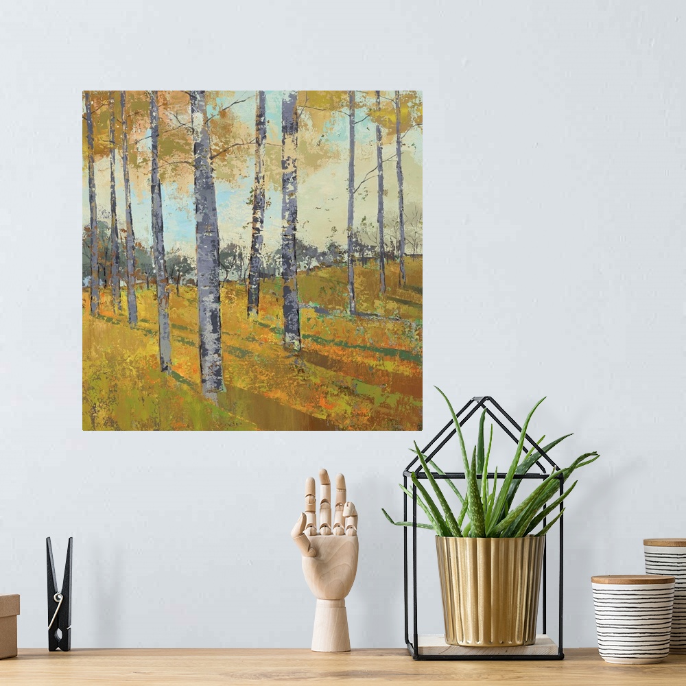 A bohemian room featuring Painting of trees casting shadows in a countryside clearing in autumn.