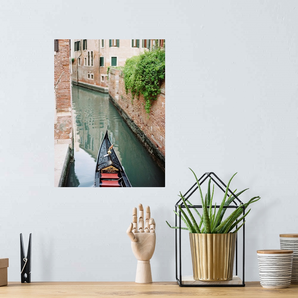 A bohemian room featuring Photograph of the front of a gondola on the water, Venice, Italy.