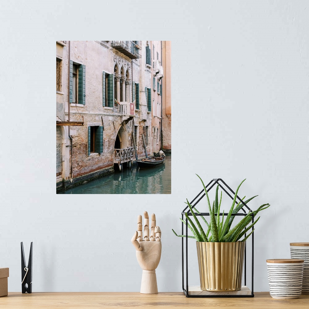 A bohemian room featuring A photograph of the facade of a house on a canal, Venice, Italy.