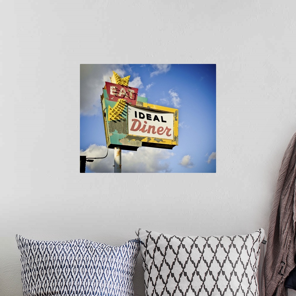 A bohemian room featuring Photograph of a retro restaurant sign against a cloudy blue sky.