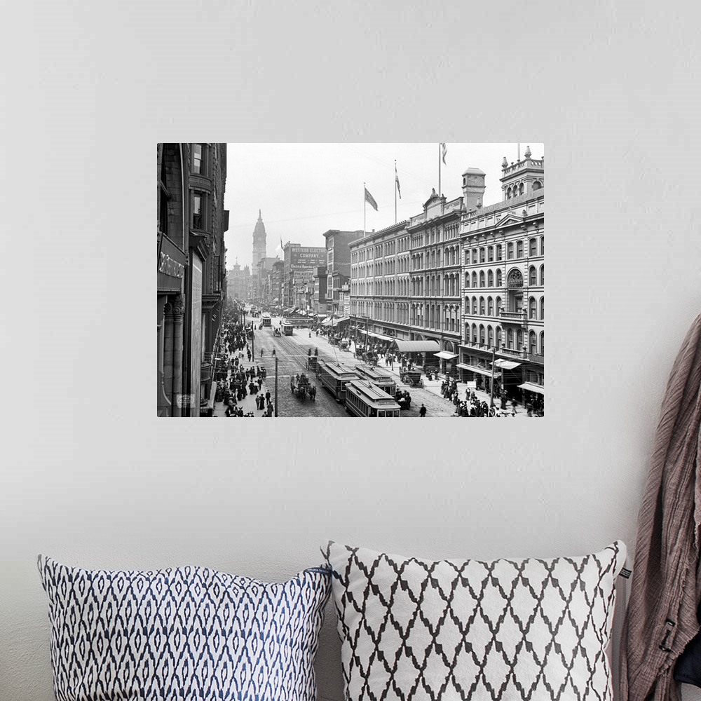 A bohemian room featuring Antiqued canvas photo print of old buildings with street cars and horses traveling through the mi...