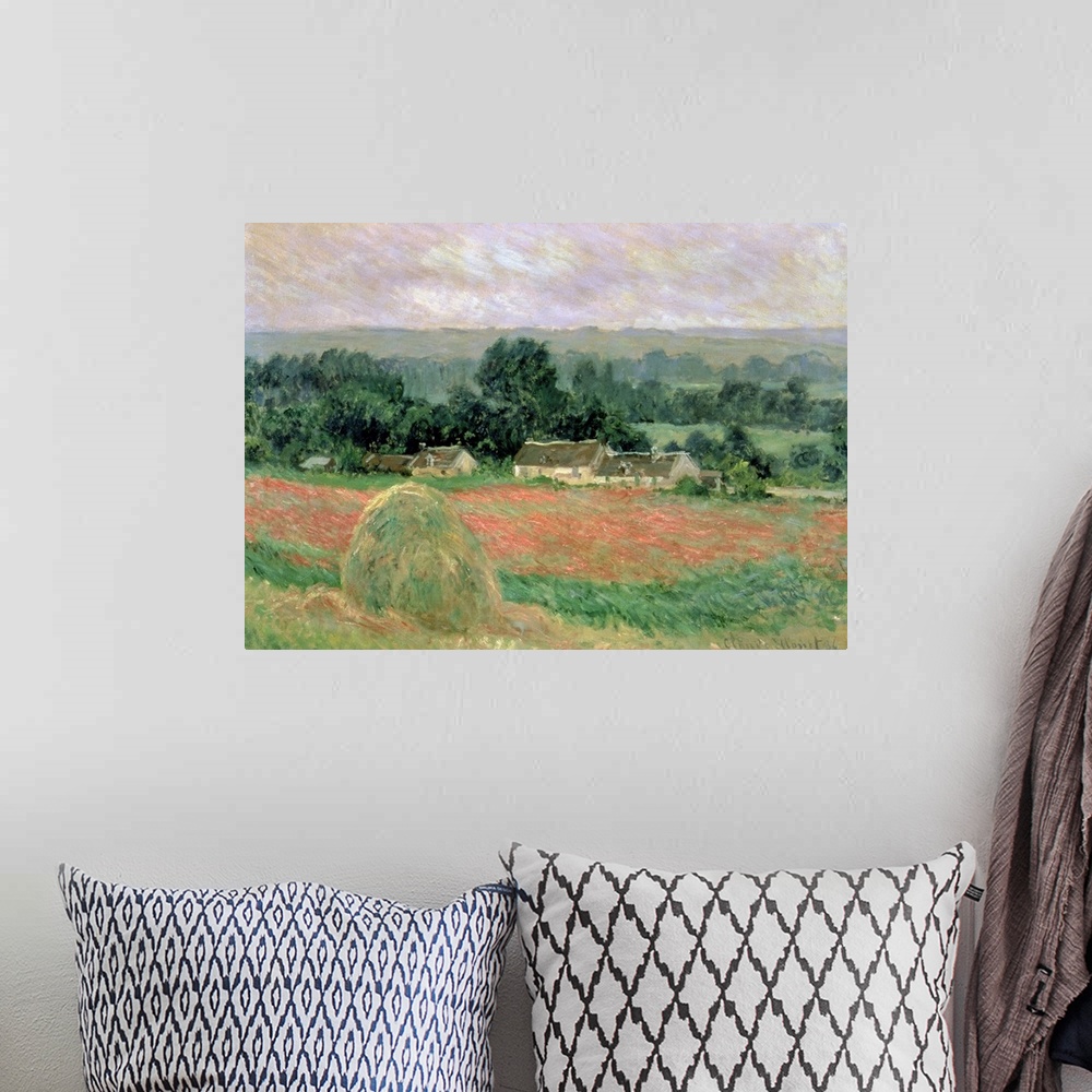 A bohemian room featuring Oil painting of hay bundle in meadow with houses and forest in the distance.