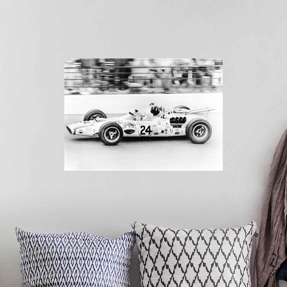 A bohemian room featuring Graham Hill, waves as his car streaks toward the finish line to win the Indianapolis 500. May 30,...