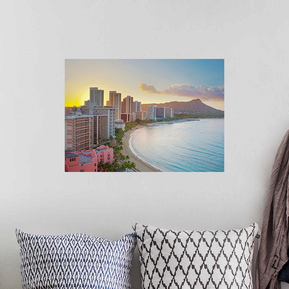 A bohemian room featuring Landscape photograph on a large wall hanging of the sun rising over buildings along Waikiki Beach...