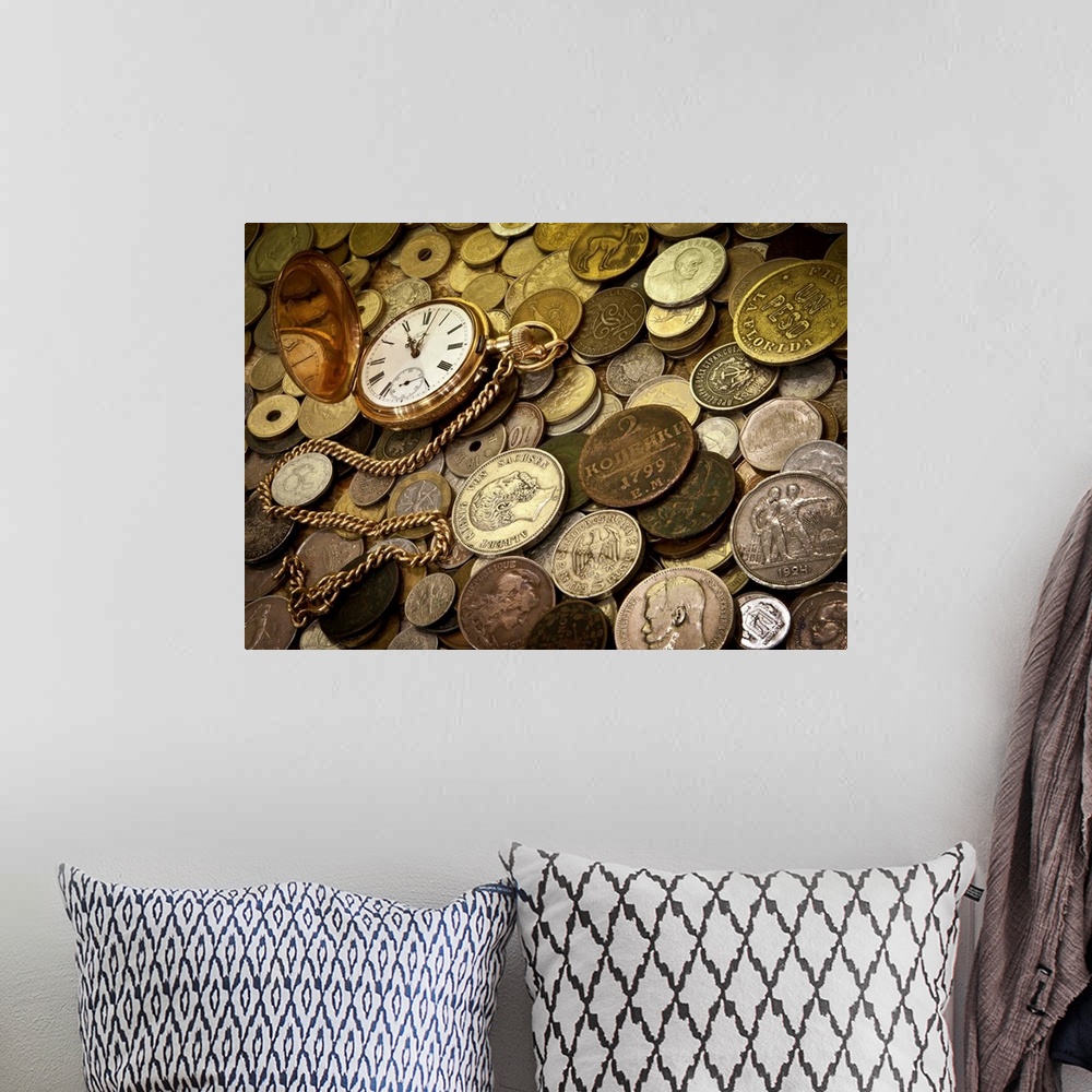 A bohemian room featuring A collection of coins with a gold pocketwatch.
