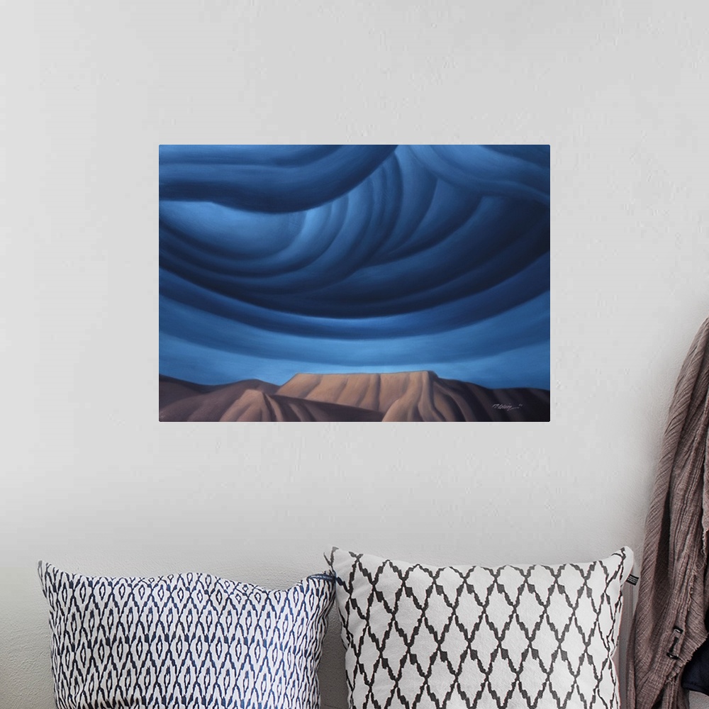 A bohemian room featuring Modernist landscape painting of cobalt blue clouds forming over a mountainous rock formation.