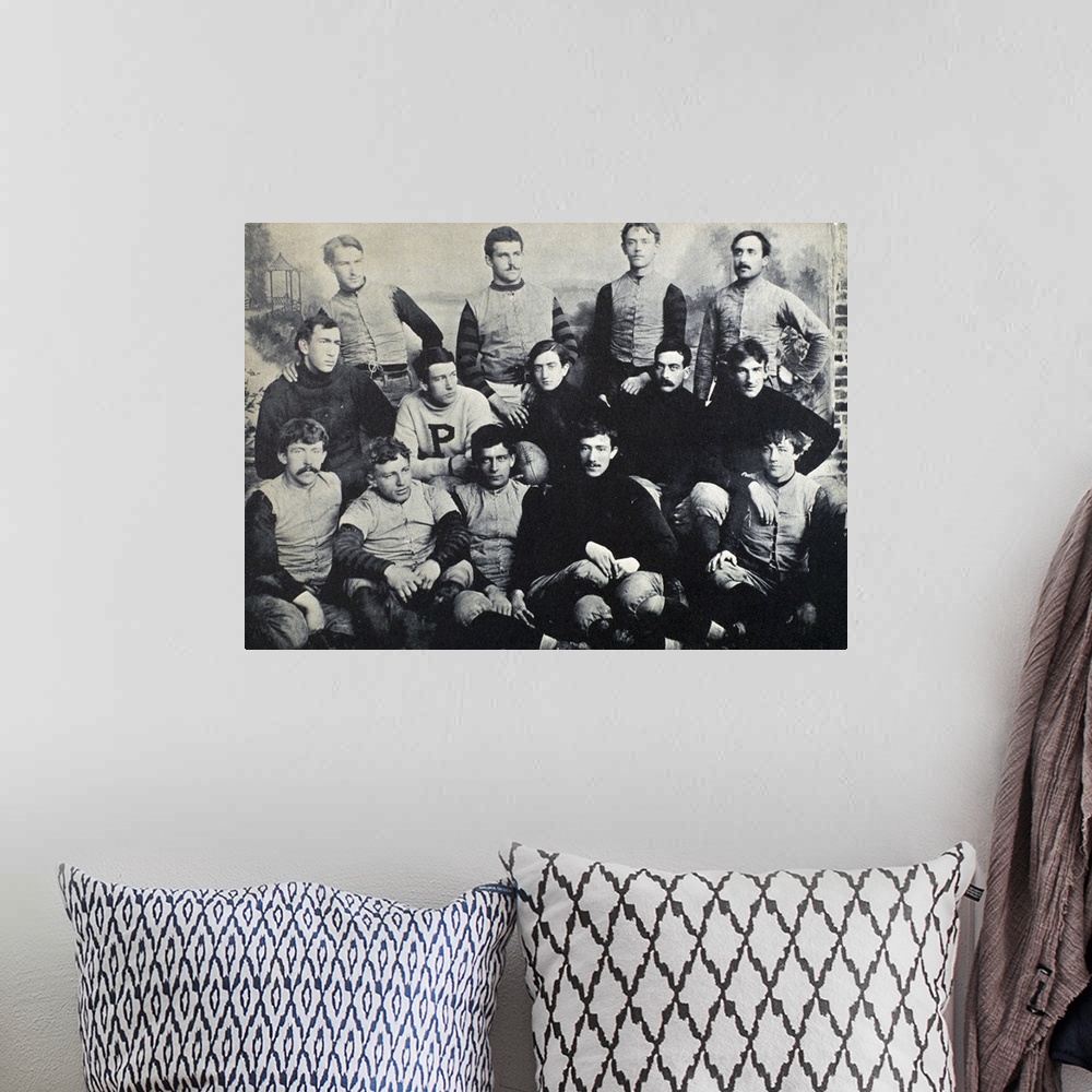 A bohemian room featuring The Princeton football team of 1890. Holding the football is the captain of the team, Edgar Allan...