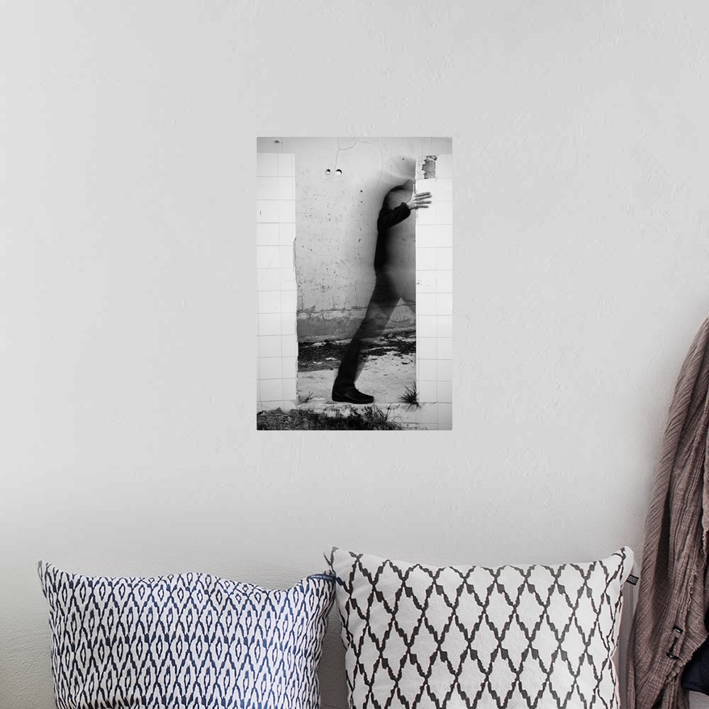 A bohemian room featuring Conceptual photograph of a male figure stepping through a wall.