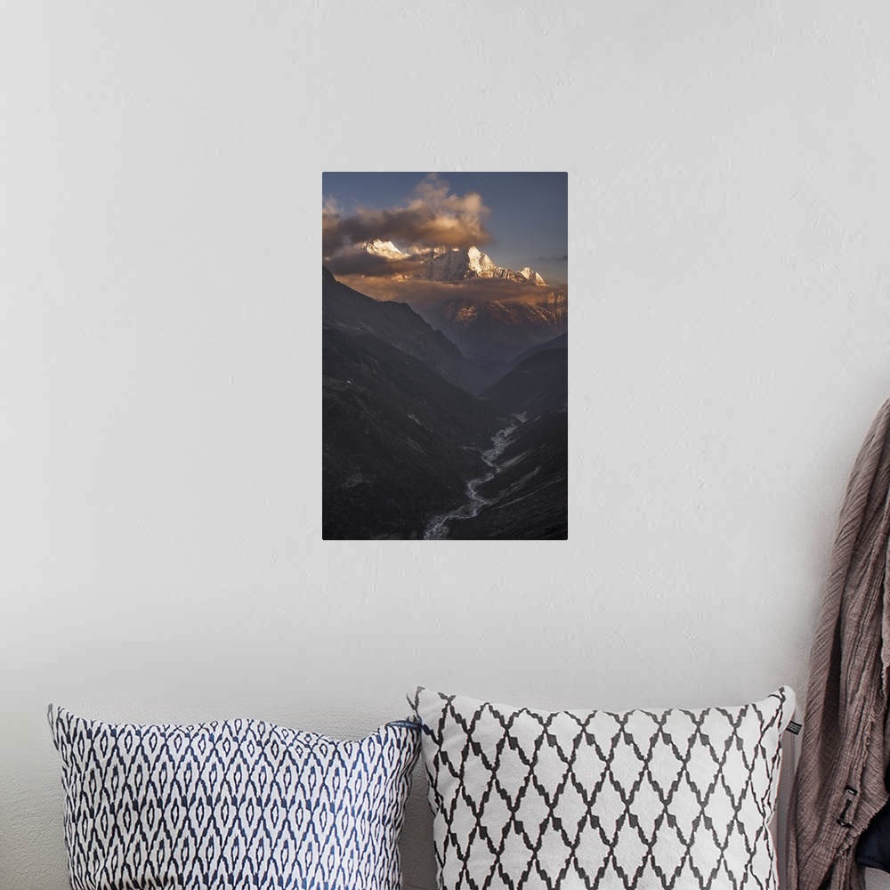 A bohemian room featuring A dynamic photograph of a mountain range above a deep valley.