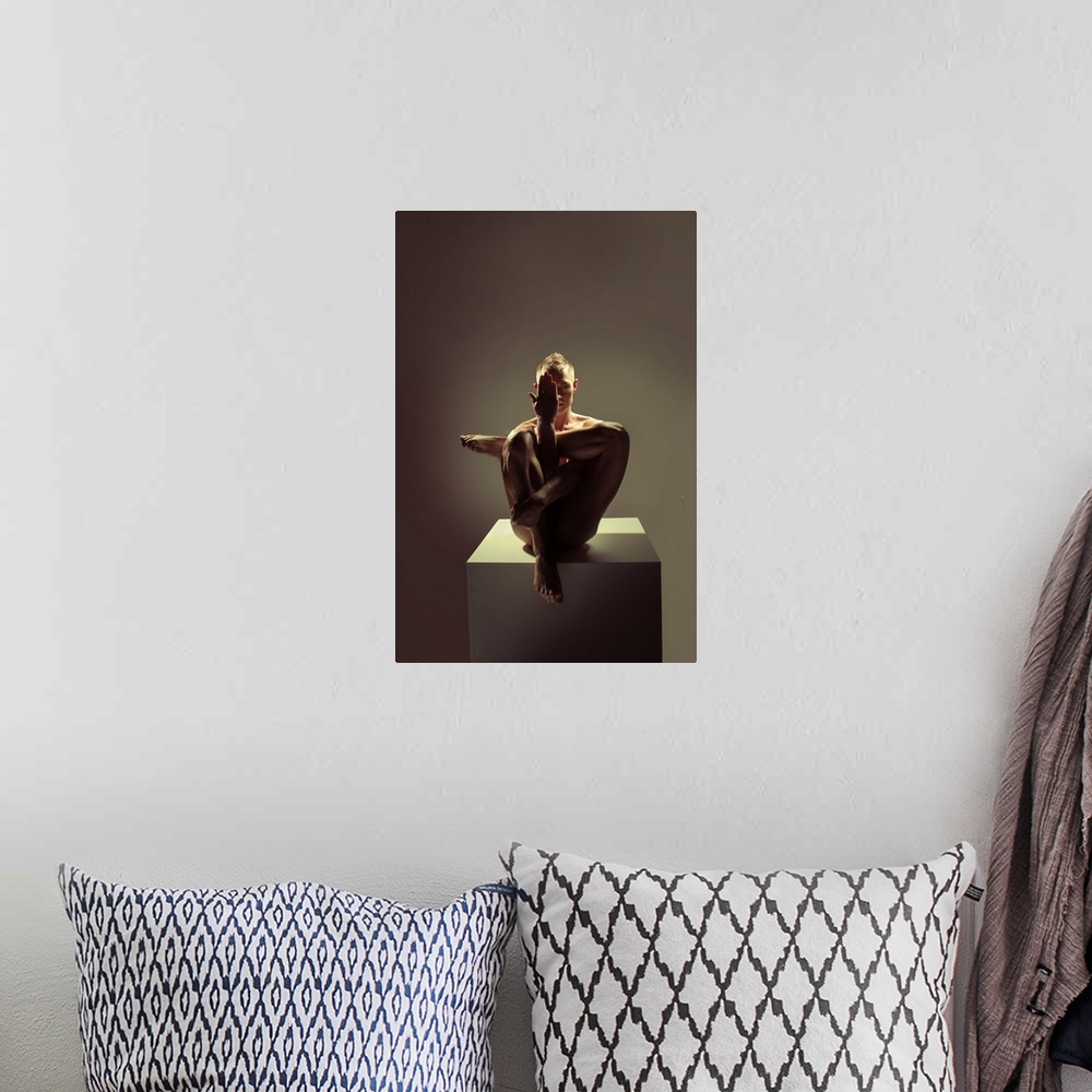 A bohemian room featuring Fine art portrait of a woman sitting on a platform creating angles with her body with dramatic li...