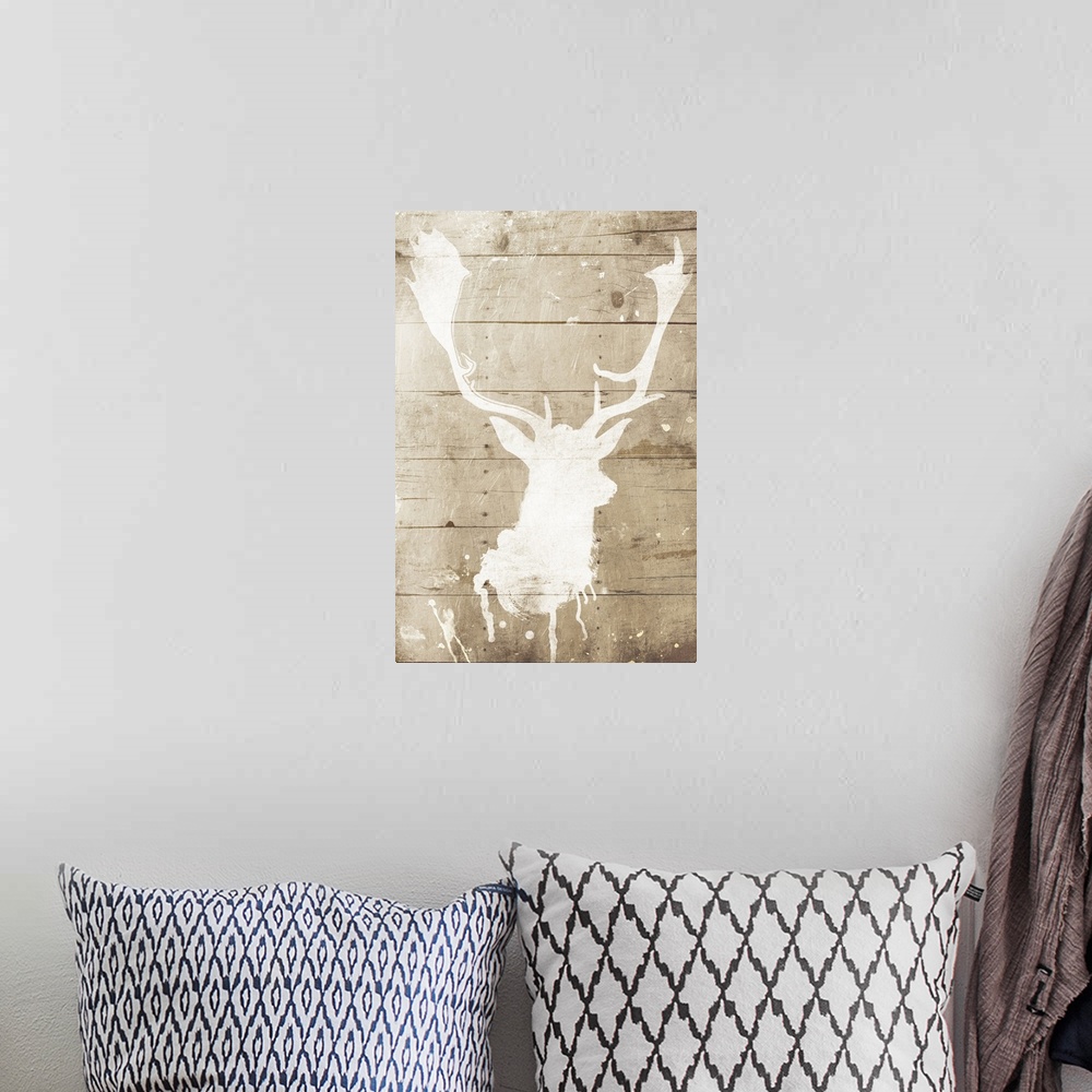 A bohemian room featuring A white silhouette of a deer painted on a wood background with some paint drips and splatter.