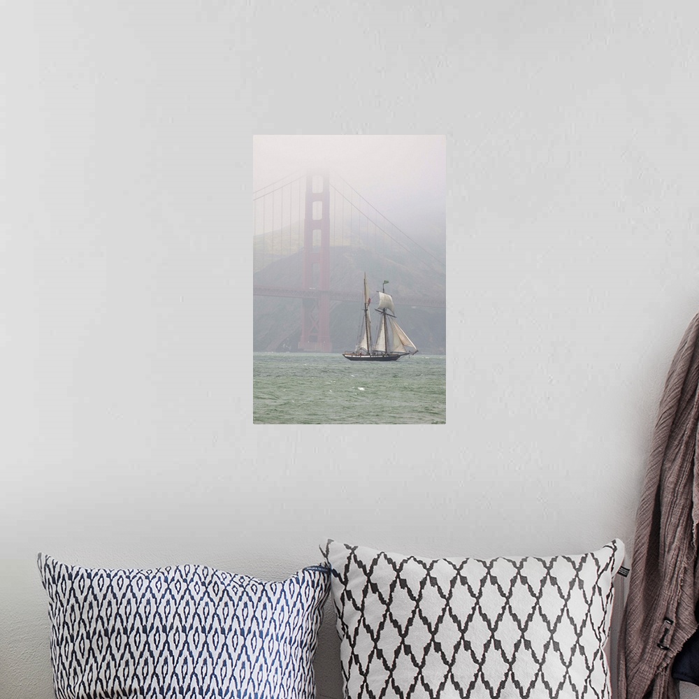 A bohemian room featuring A two masted schooner sails under the Golden Gate Bridge.