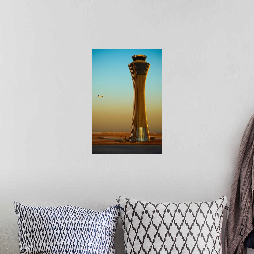 A bohemian room featuring An Airplane Flies Past The Air Traffic Control Tower At The Beijing Airport, China