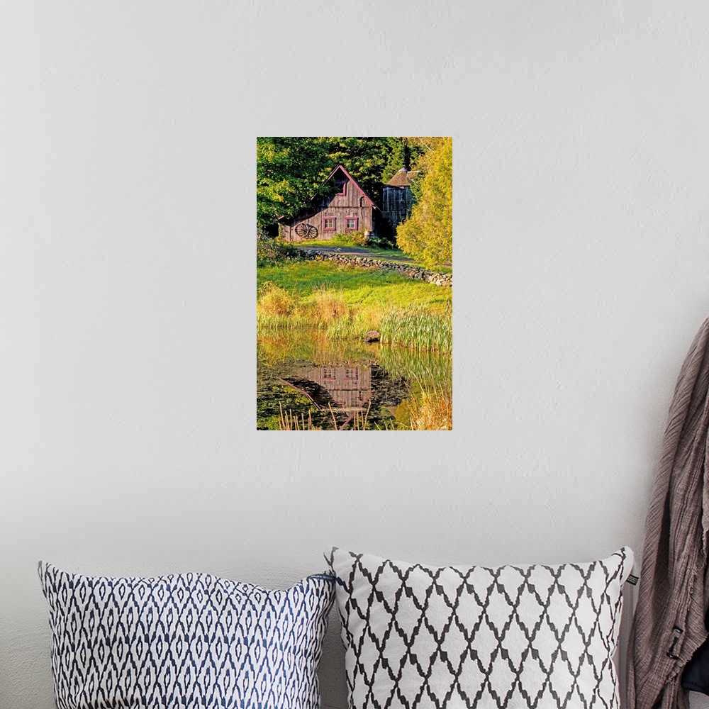 A bohemian room featuring An Old Barn Reflected In Pond; Ville De Lac Brome, Quebec, Canada