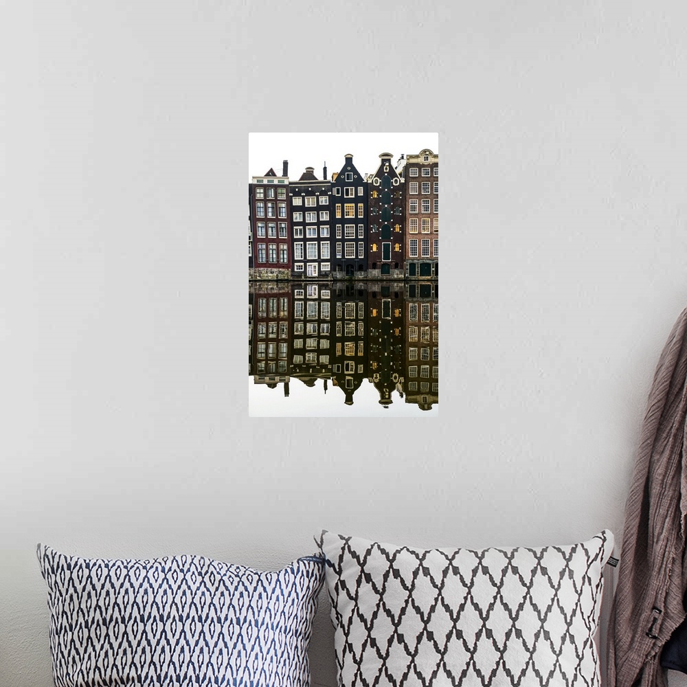 A bohemian room featuring Building facades with a mirror image reflecting in a canal; Amsterdam, Netherlands