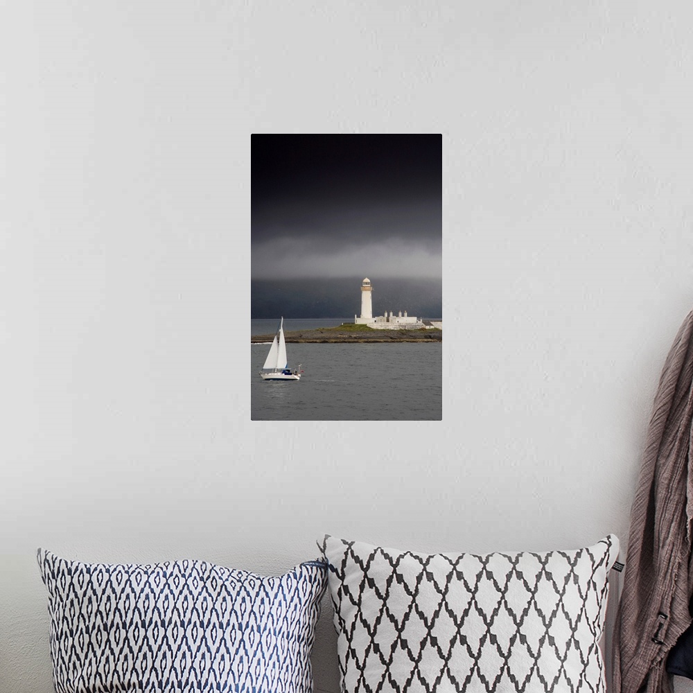 A bohemian room featuring Sailboat Near A Shore With A Lighthouse; Eilean Musdile In The Firth Of Lorn, Scotland