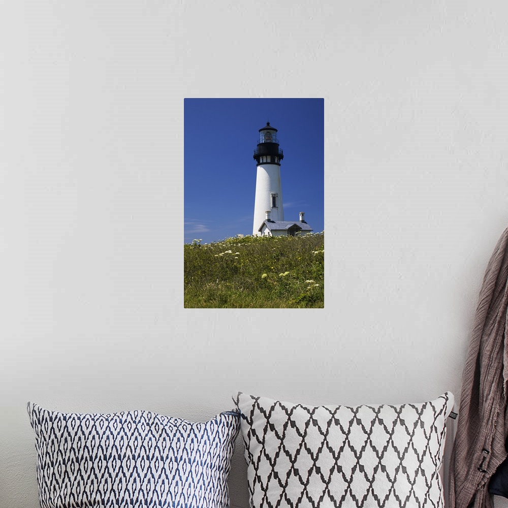 A bohemian room featuring White Lighthouse With A Blue Sky And Wildflowers; Newport, Oregon, USA