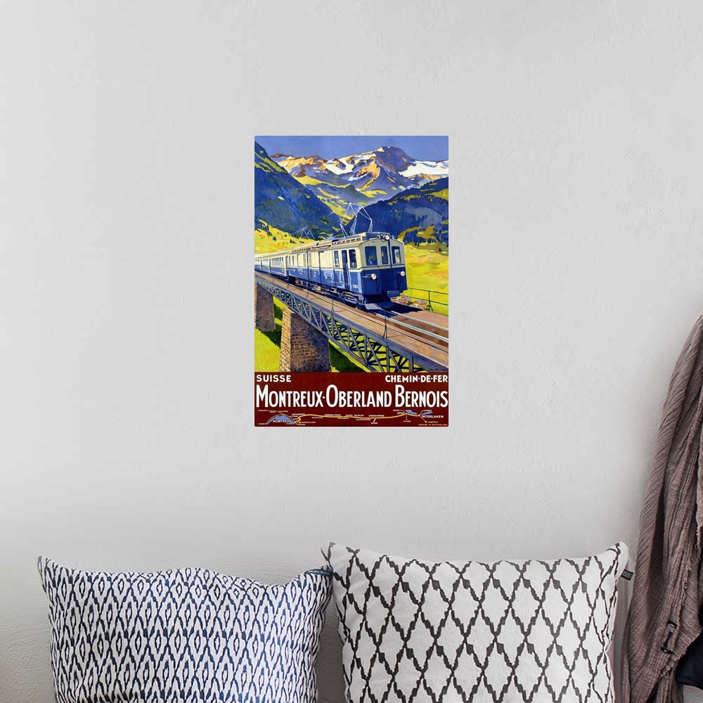 A bohemian room featuring Old advertising print for train.  There is an image of train crossing a  bridge with snow covered...