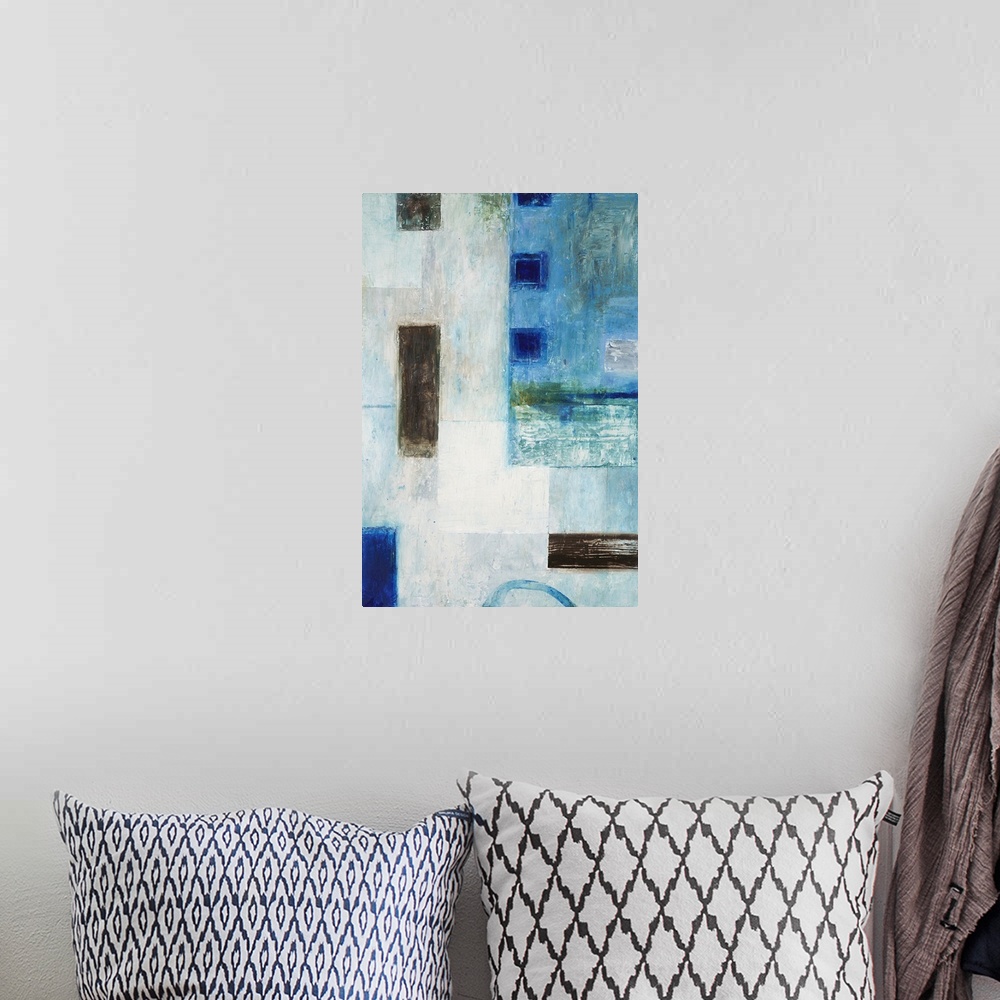A bohemian room featuring Abstract geometric artwork in blue tones with black squares.