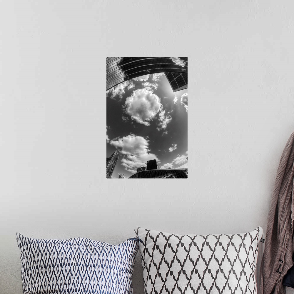 A bohemian room featuring Black and white photograph of the sky in the city