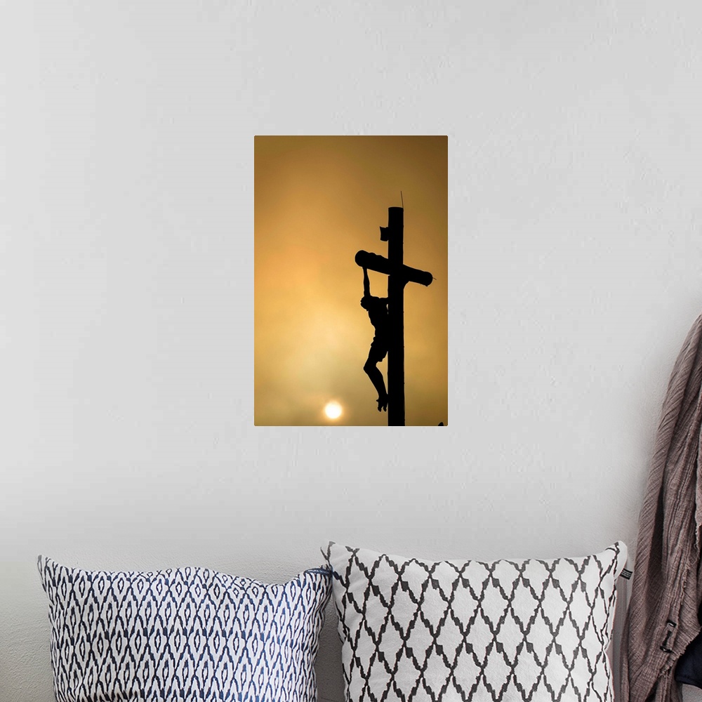 A bohemian room featuring Silhouette of Christ on the cross at sunset.