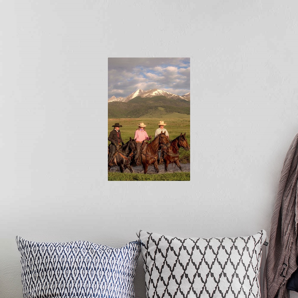 A bohemian room featuring Photograph of three cowgirls on horseback crossing a river.