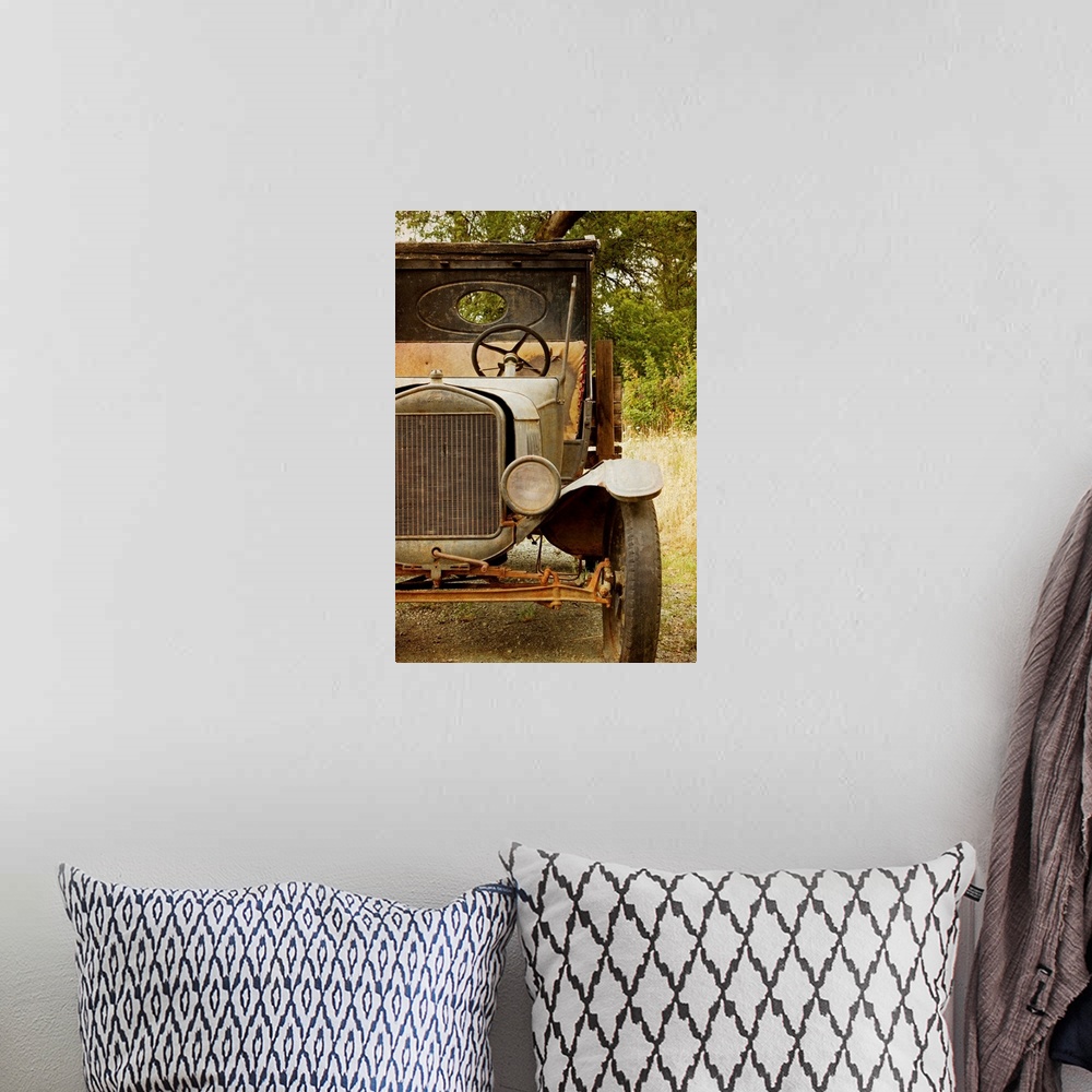 A bohemian room featuring Photograph of a derelict truck sitting in a clearing in the countryside.