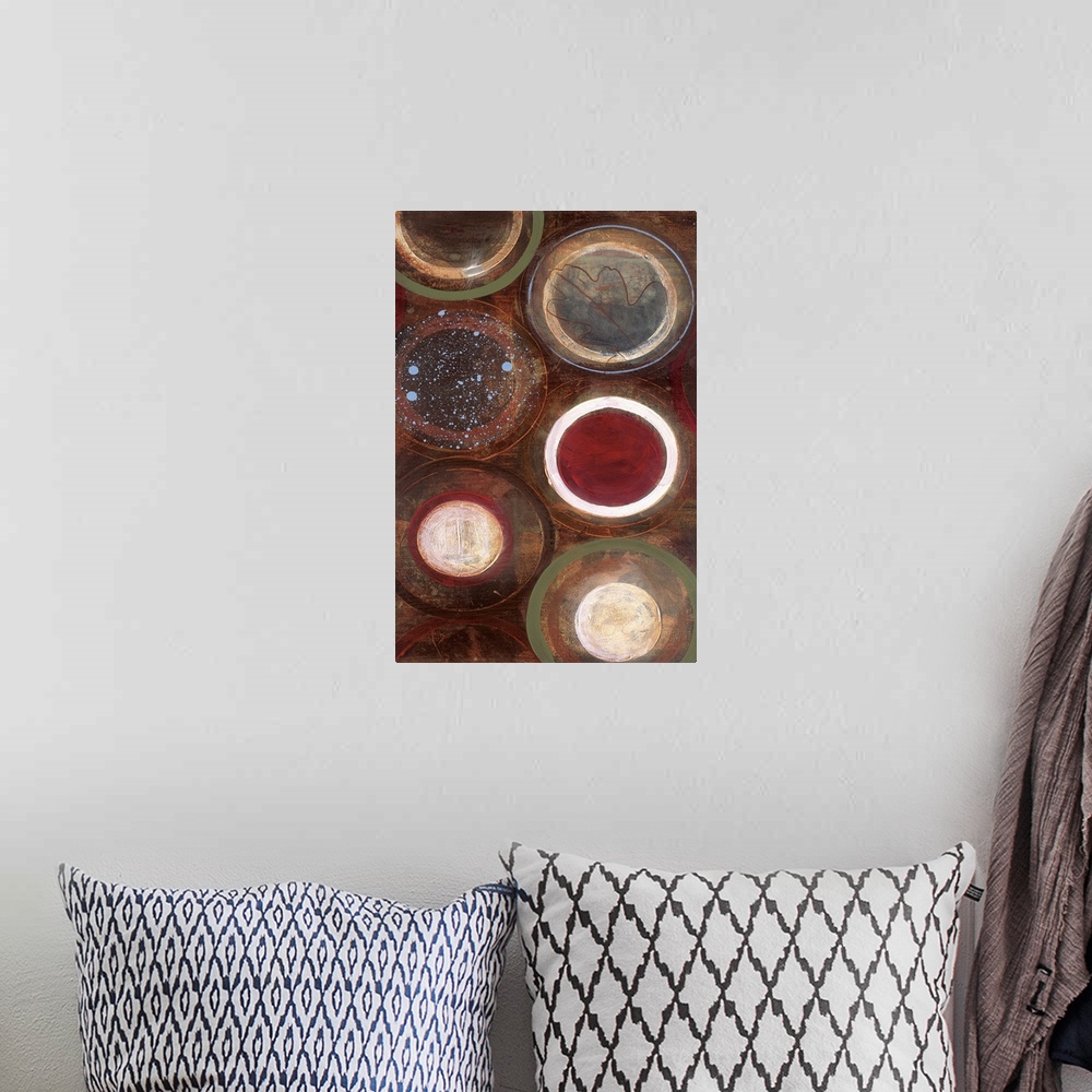 A bohemian room featuring Vertical modern painting of circles in multiple colors with speckles of blue paint overlapping.