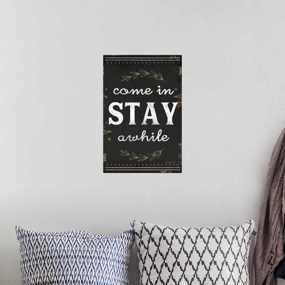 A bohemian room featuring A digital illustration of "Come in STAY awhile" on a weathered dark background.