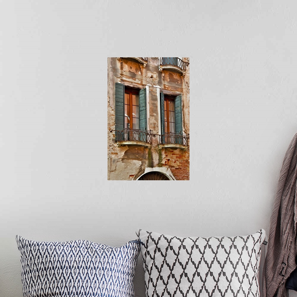 A bohemian room featuring Old and colorful doorways and windows in Venice, Italy.