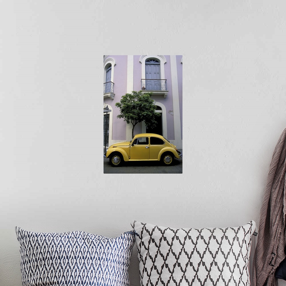 A bohemian room featuring Puerto Rico, Ponce, Historic District. 19th century pink and white house with yellow VW Beetle pa...