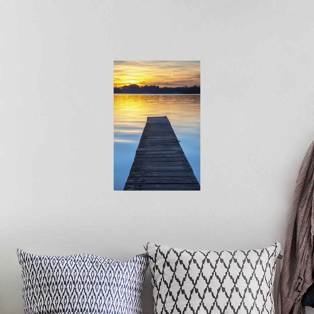 A bohemian room featuring Sunset over serene water of lake Paterwoldsemeer.