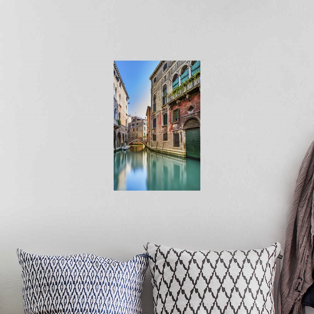 A bohemian room featuring Venice cityscape, narrow water canal, bridge and traditional buildings. Italy, Europe.