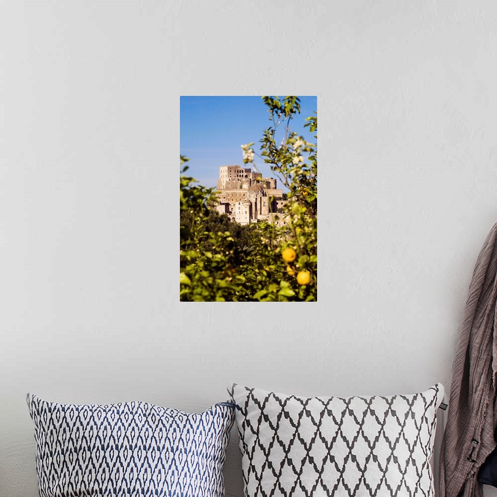 A bohemian room featuring Italy, Campania, Ischia Island, Ischia Ponte, Aragonese Castle with lemon tree