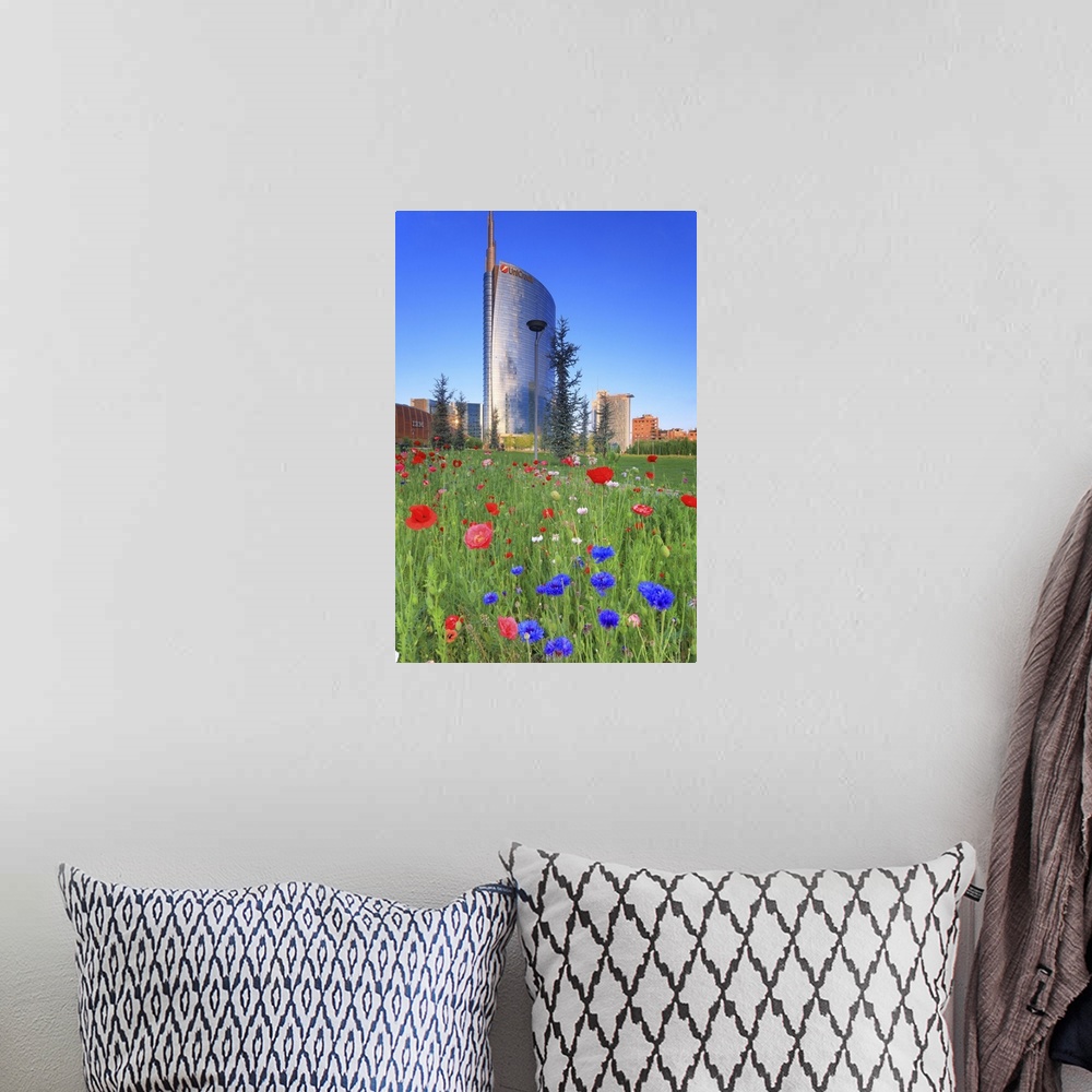 A bohemian room featuring Italy, Lombardy, Milano district, Milan, Porta Nuova, Flowers and the Unicredit Tower at dawn.