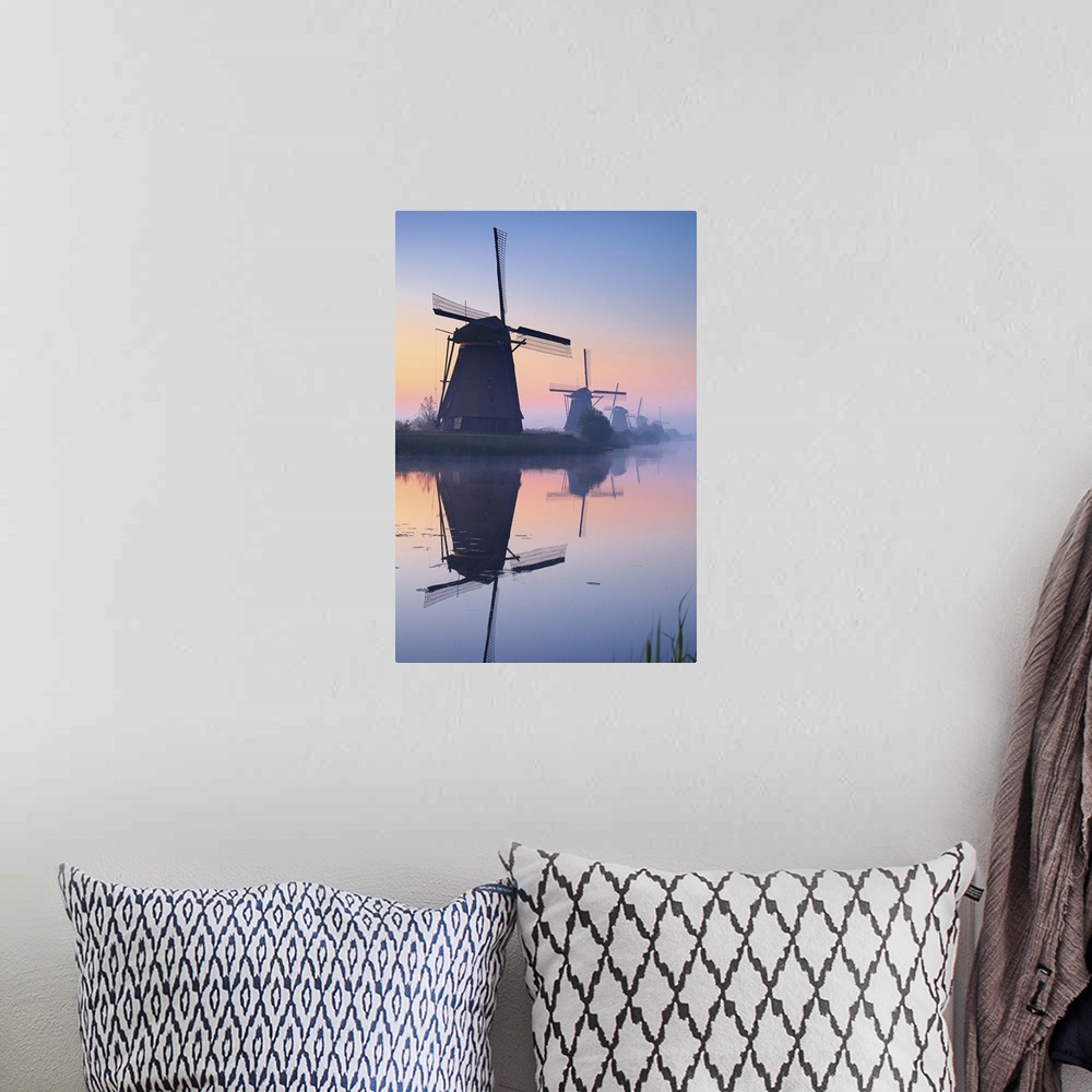A bohemian room featuring Netherlands, South Holland, Kinderdijk, Windmills at sunrise.