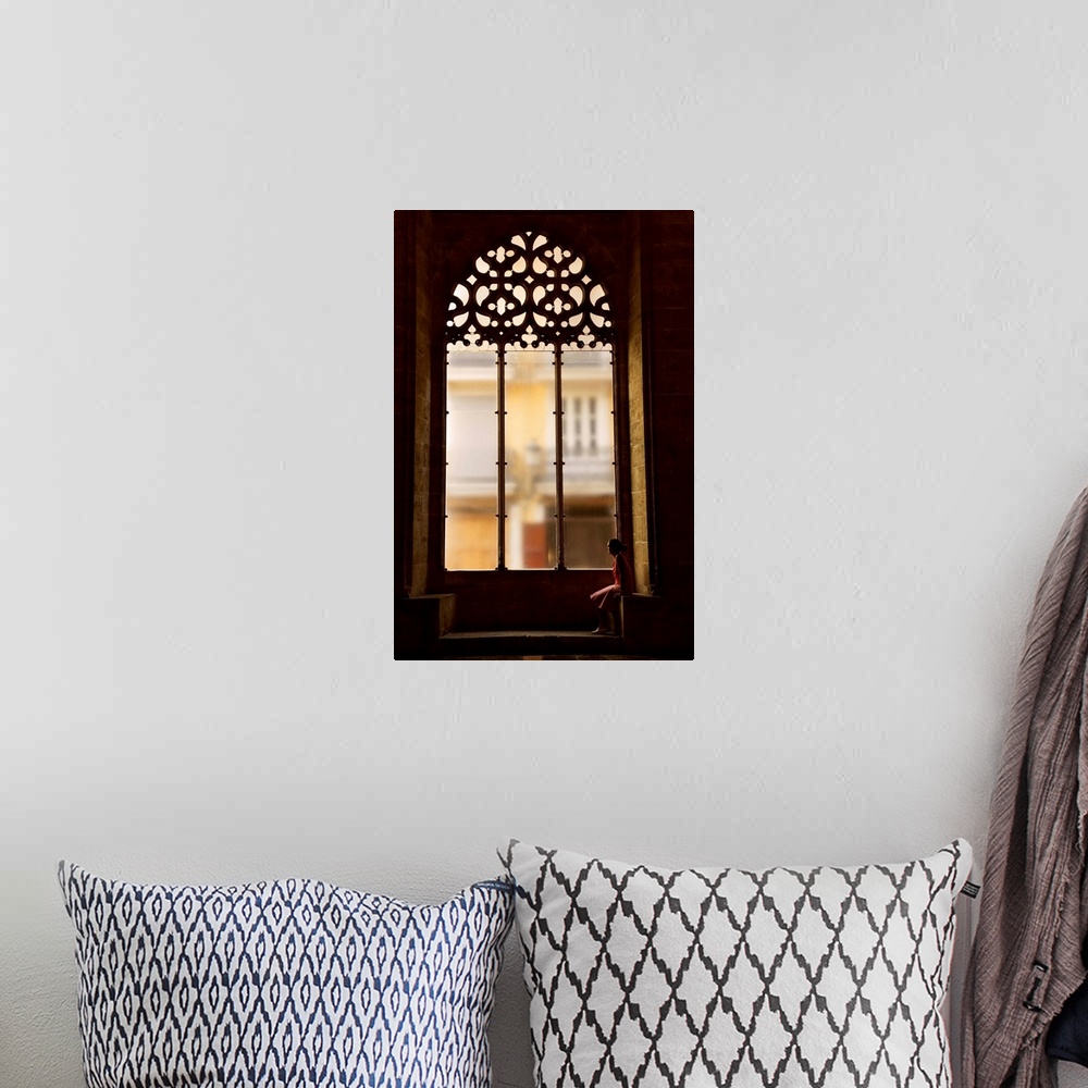 A bohemian room featuring Spain, Comunidad Valenciana, Valencia, Hall of Lonja de La Seda, Woman sitting by a window